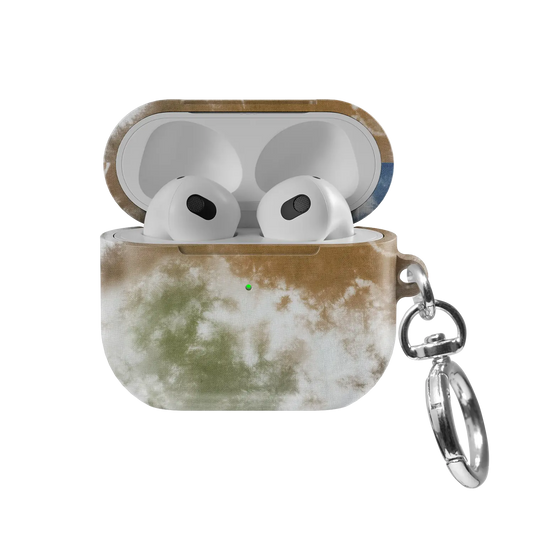 Indigo Soil AirPods case — front view with lid open, showing brown-to-blue tie-dye swirl and AirPods nested inside