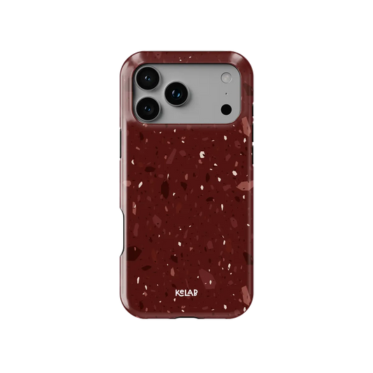 Crushed Merlot wine red terrazzo Tough iPhone case, front view showing the pattern.