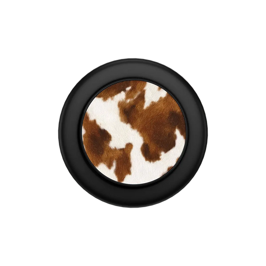 Black round MagSafe phone grip with brown and white cow print center and built-in strong magnets.