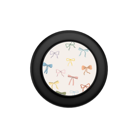 colorful hand-drawn bow print on ivory MagSafe phone grip, black hardware – folded flat, top view