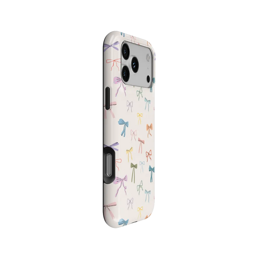 colorful hand-drawn bow print on ivory iPhone case in Tough finish – side angle view showing button cutouts and wraparound edge