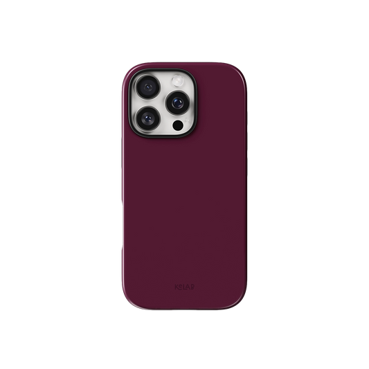 Burgundy phone case in solid pinkish-red with minimalist style by KELAB, designed for iPhone with precise camera cutout and sleek finish.
