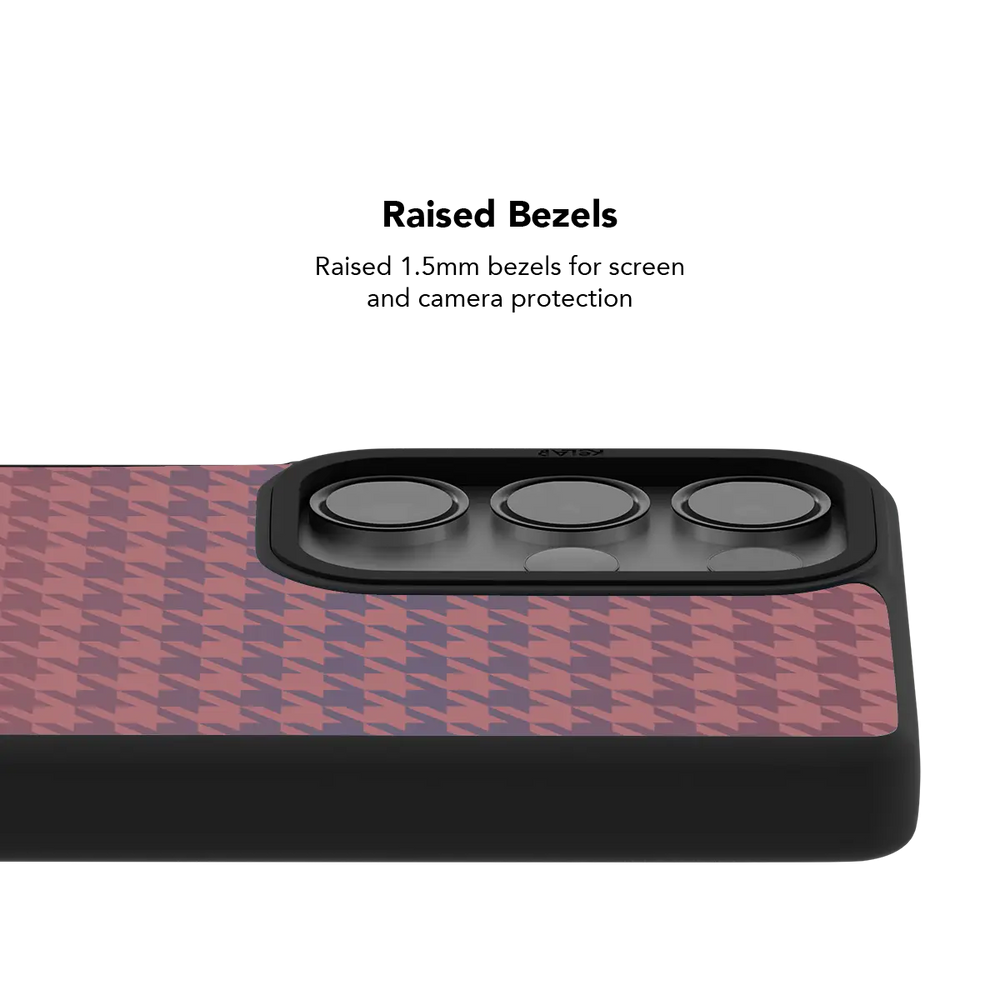 Raised bezel on the pink houndstooth Galaxy case lifting the camera lenses clear of a flat surface
