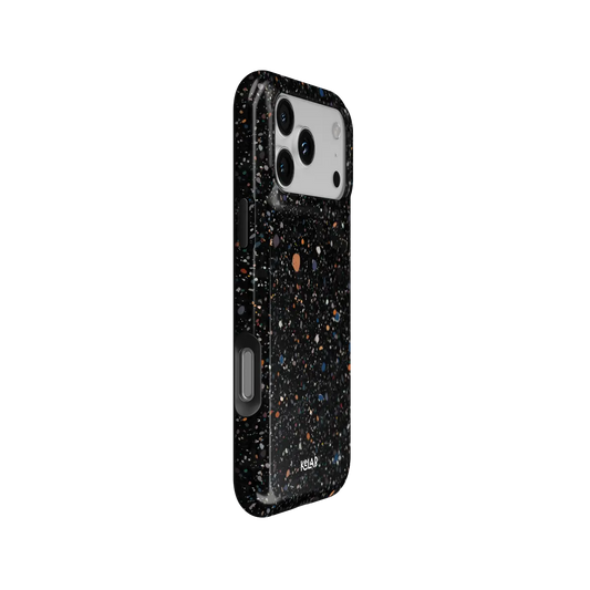 Obsidian Mist black paint splatter Tough iPhone case, side view showing the pattern wrapped around the shell.
