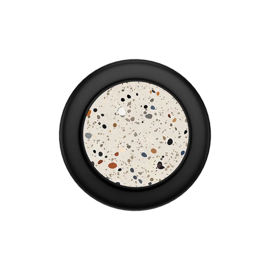Black MagSafe phone grip with speckled ivory haze pop grip circle and built-in strong magnets.