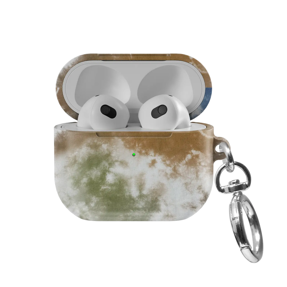Indigo Soil AirPods case — front view with lid open, showing brown-to-blue tie-dye swirl and AirPods nested inside