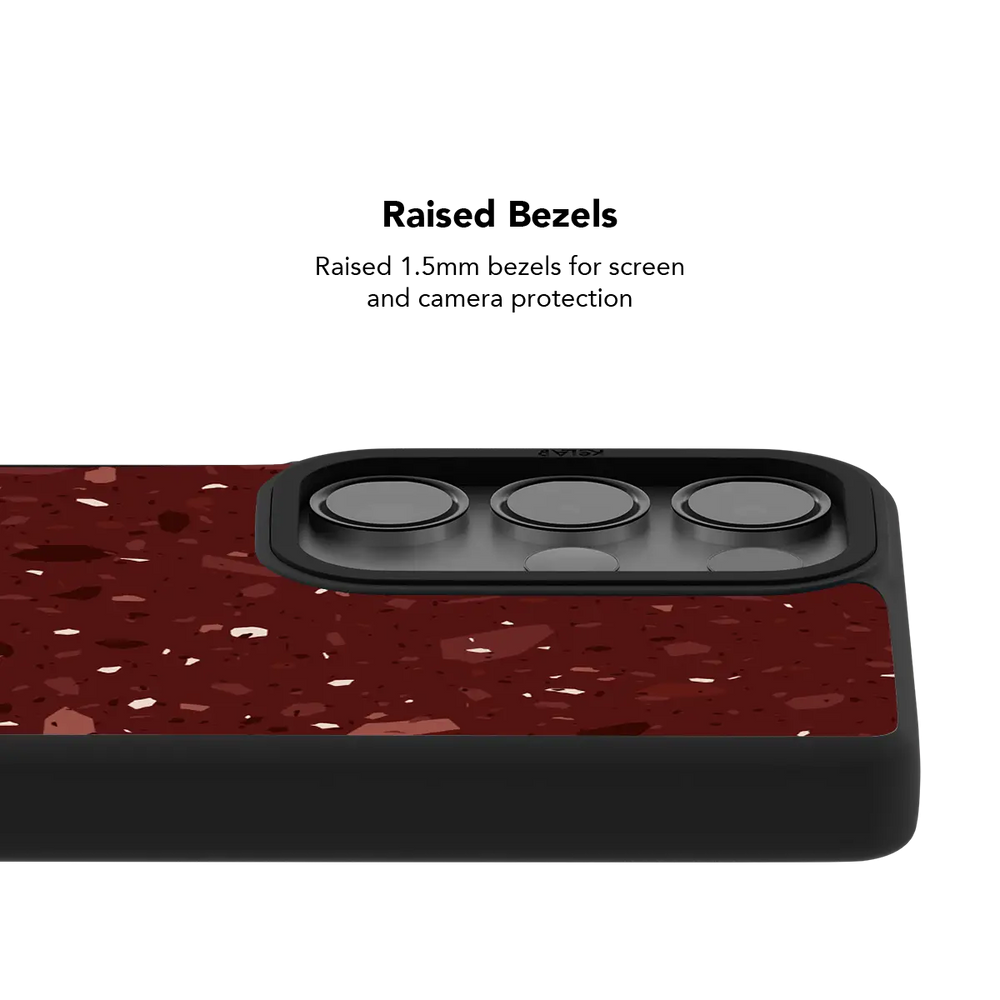 Raised bezel on the burgundy terrazzo Galaxy case lifting the camera lenses clear of a flat surface