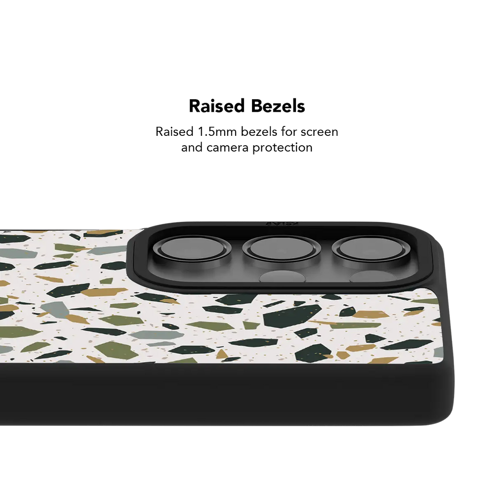 Raised bezel on the white terrazzo Galaxy case lifting the camera lenses clear of a flat surface