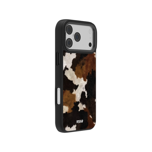 side view of an iPhone 17 pro max case with cow print design on a white background