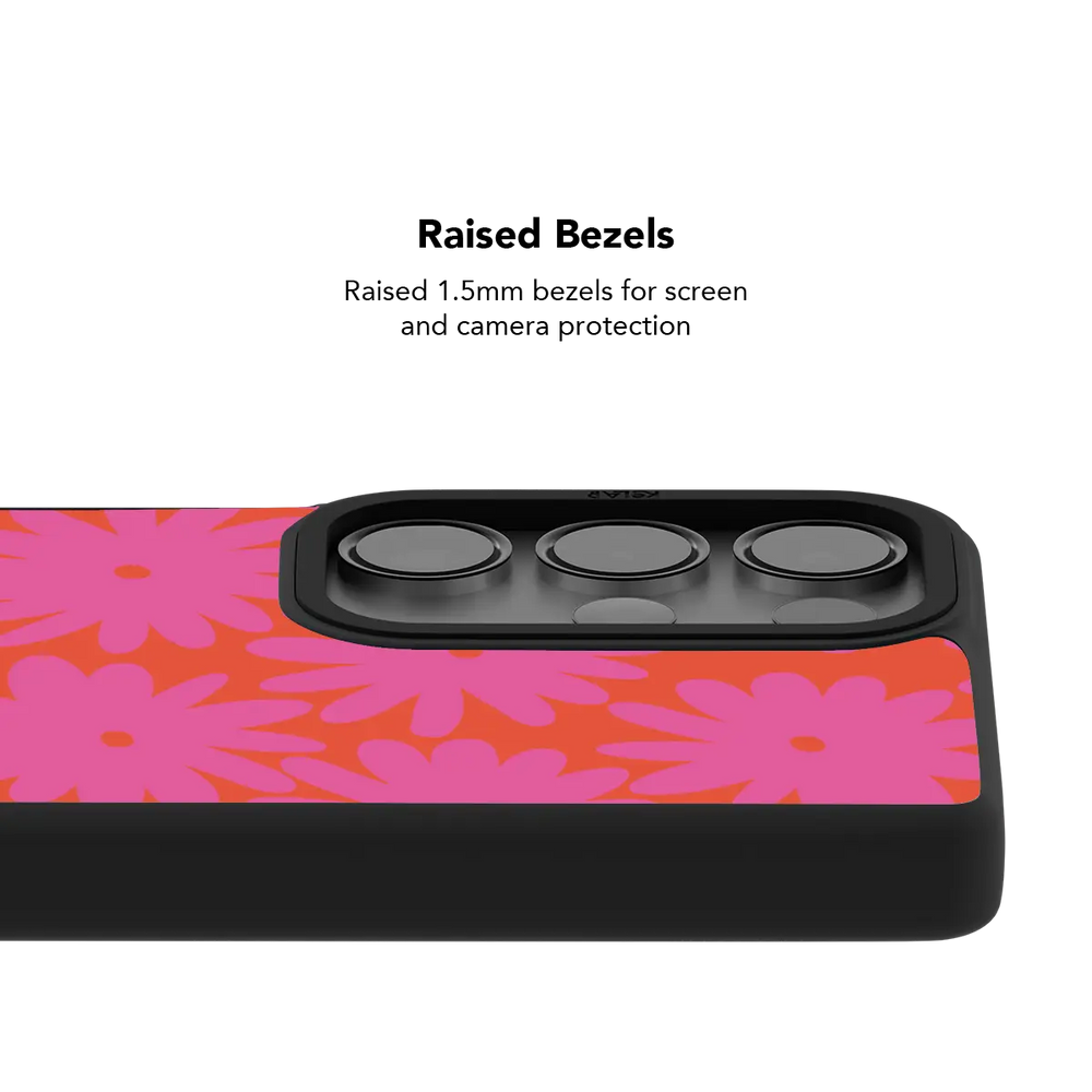 Raised bezel on the pink daisy Galaxy case lifting the camera lenses clear of a flat surface