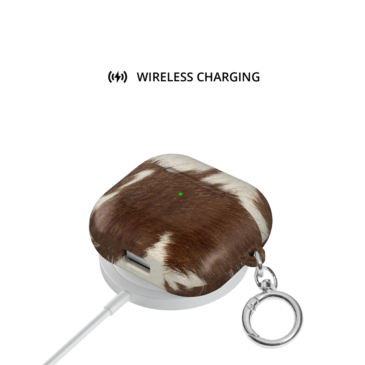Rodeo Drive brown and white cow print AirPods case on wireless charging pad