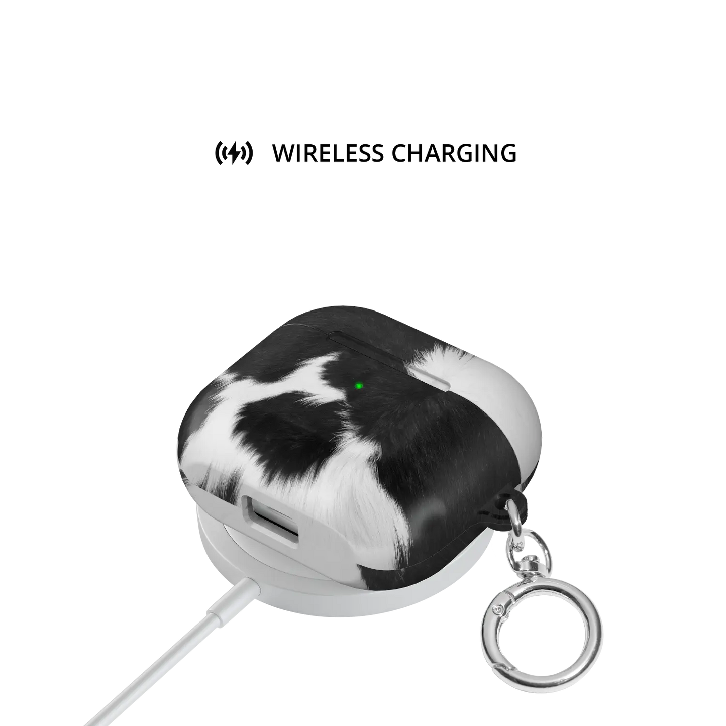Cow Bell black and white cow print AirPods case on wireless charging pad