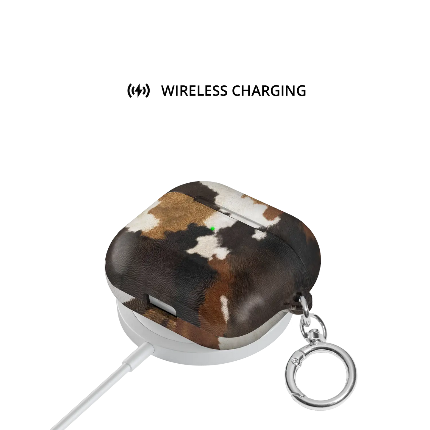 Cattle Drive | Brown & Black Cow Print AirPods Case - shown on wireless charger