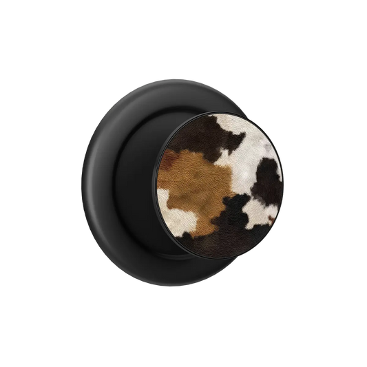 Cow print MagSafe phone grip pop grip with built-in strong magnets and black base.