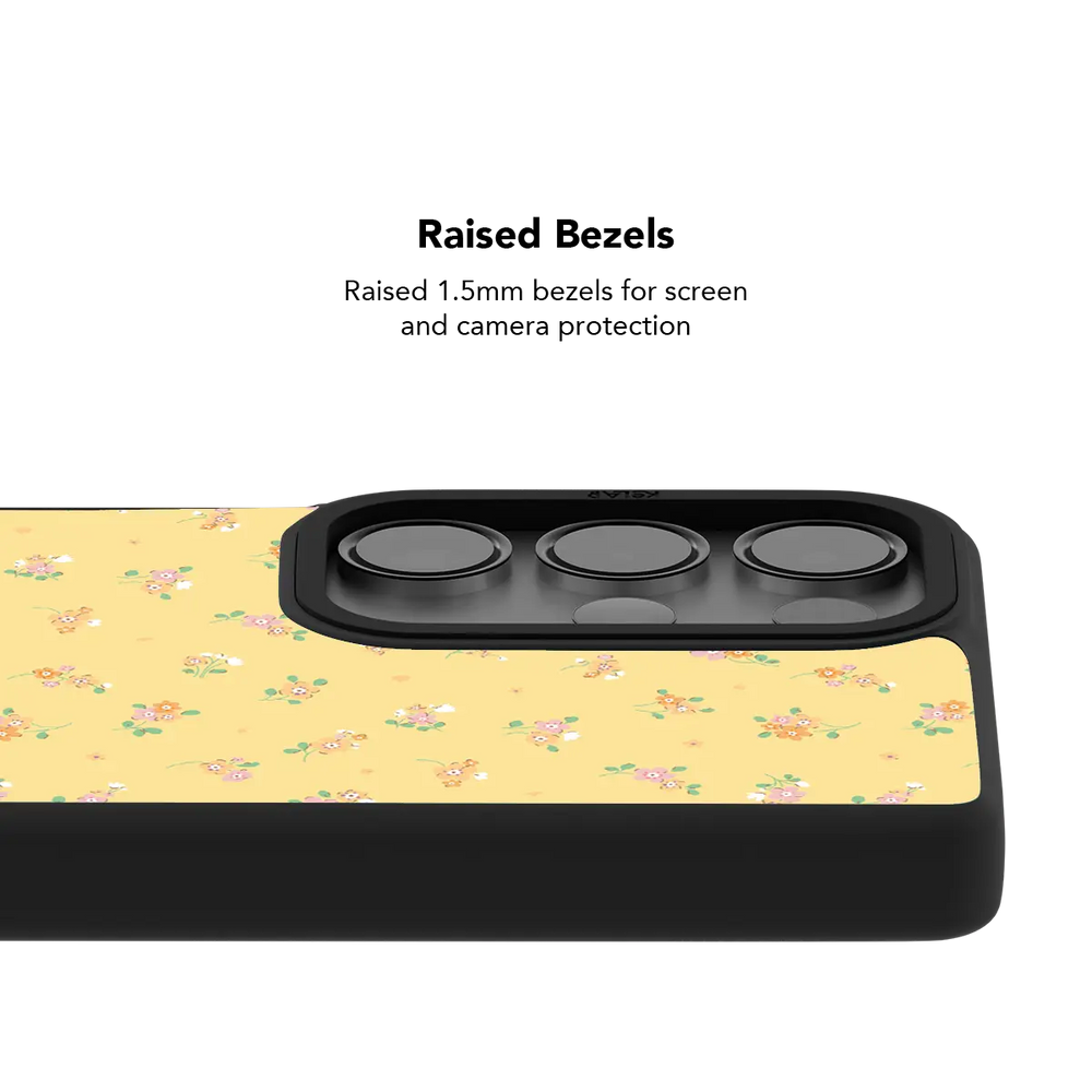 Raised bezel on the yellow floral Galaxy case lifting the camera lenses clear of a flat surface