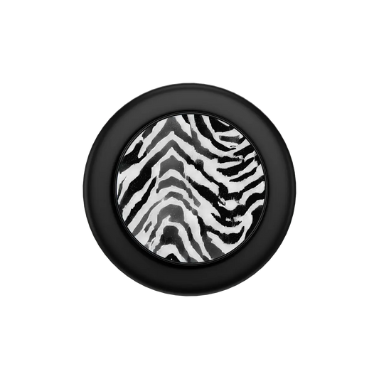 Zebra Crossing black and white zebra print MagSafe phone grip with black ring folded flat, top down view.