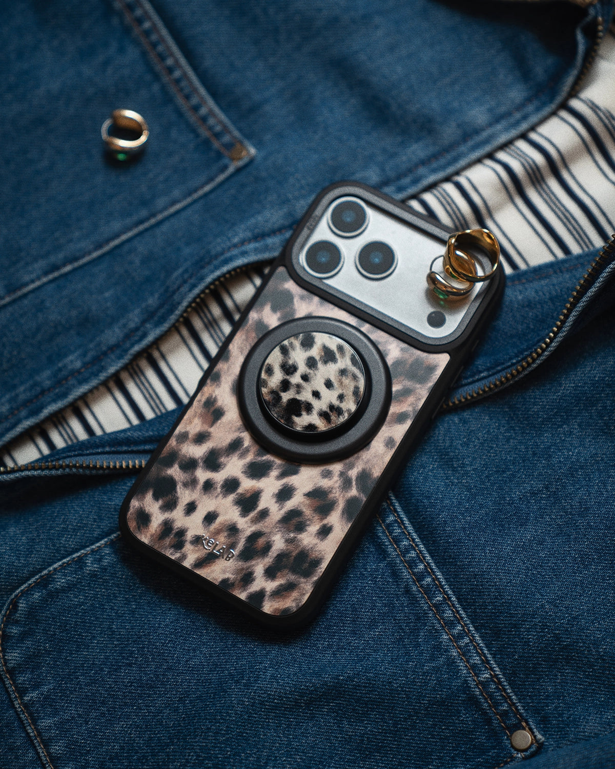 Phone case with leopard print design on a denim surface