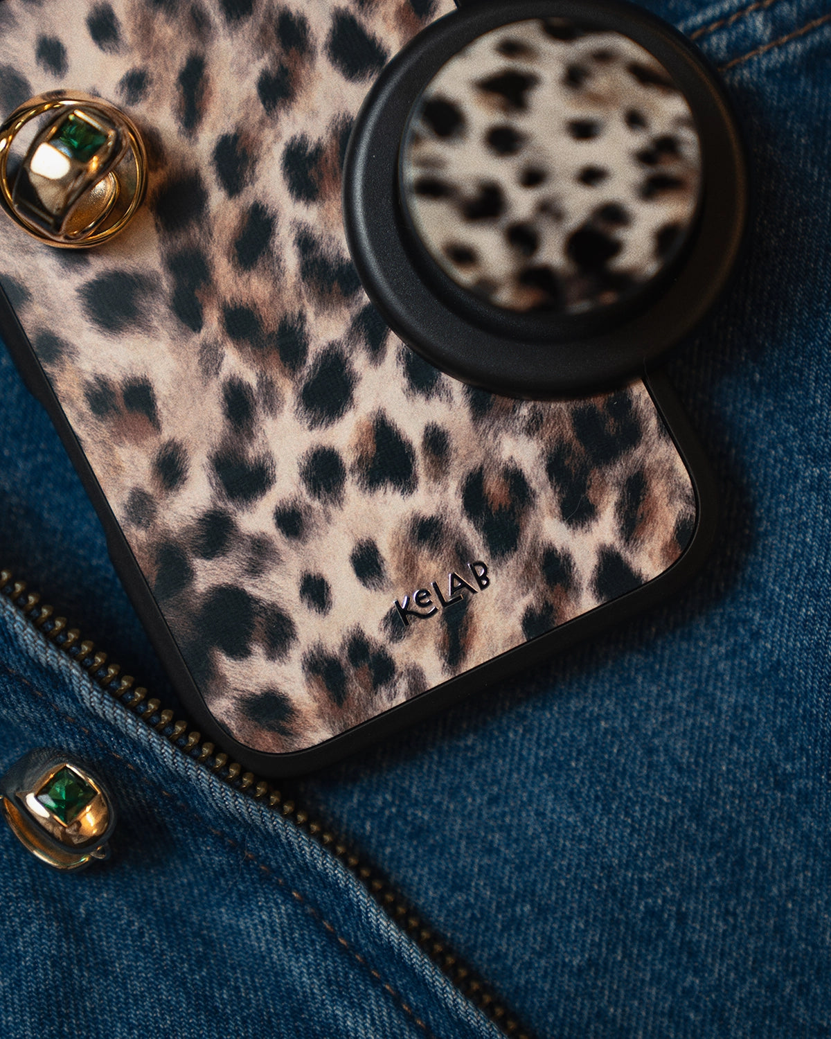 Leopard print phone case with a pop socket on a denim background