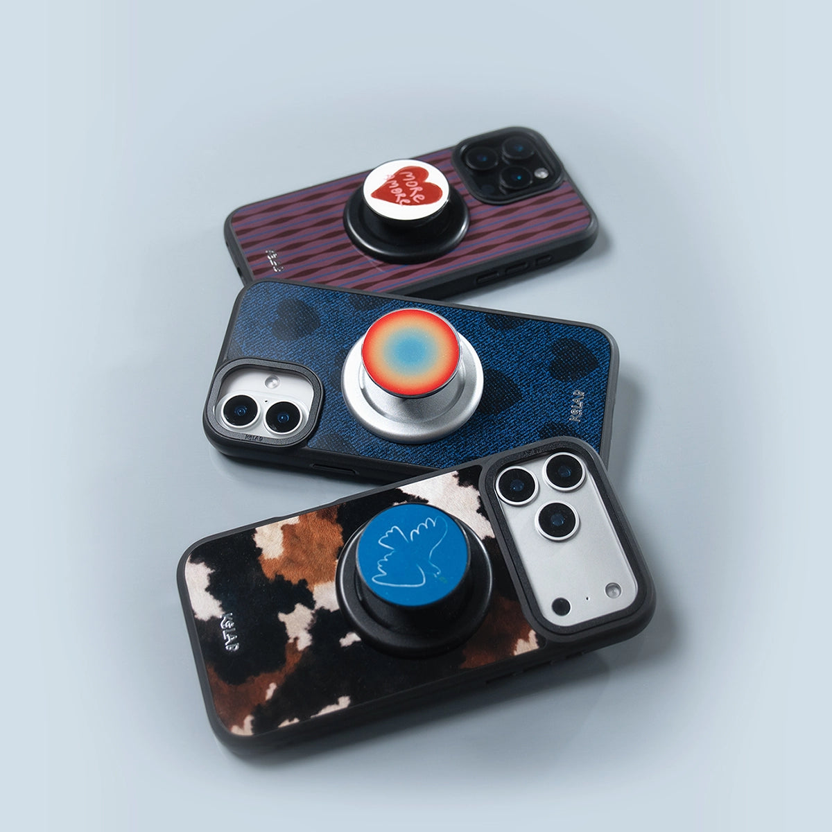 Three phone cases featuring various patterned MagSafe phone grips for style and security.