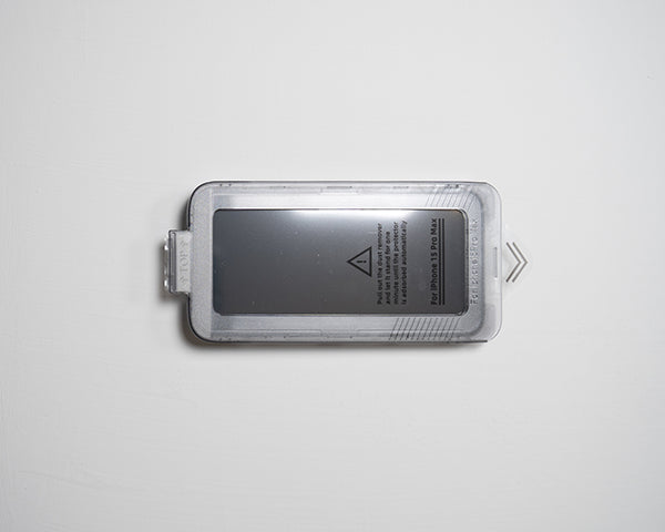A screen protector in an easy install tray, featuring instructions and a warning label.