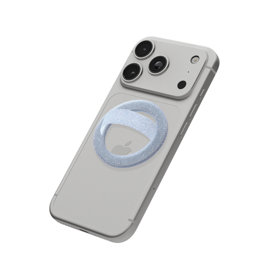 Icy blue glitter MagSafe loop grip attached to the back of an iPhone