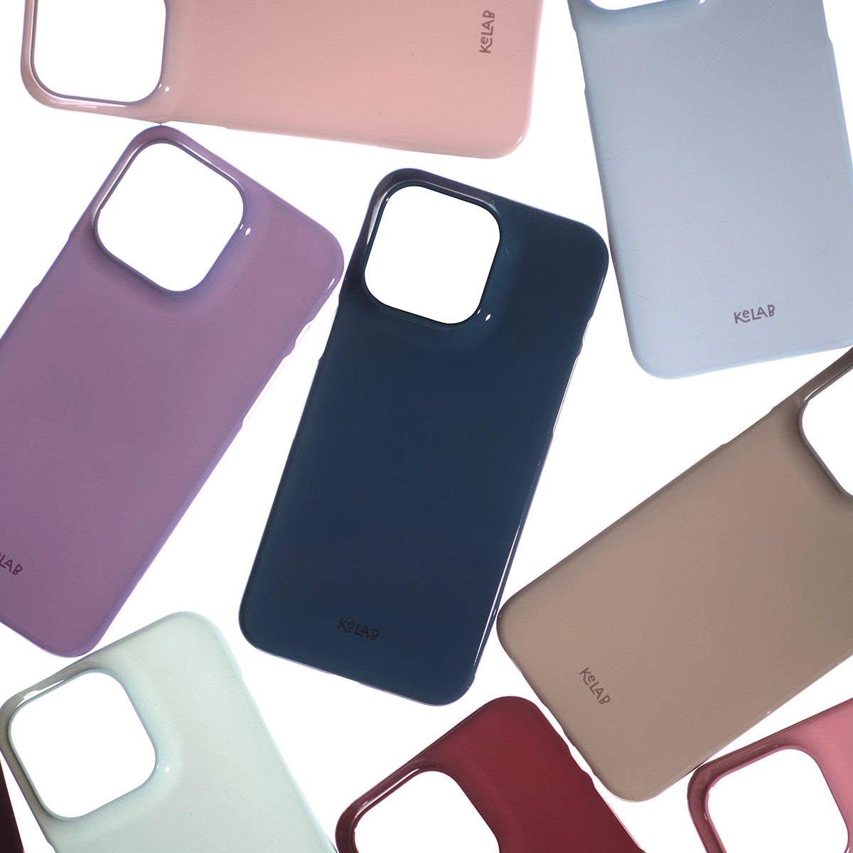 Assorted smartphone cases in pink, purple, navy, beige, and light blue with camera cutouts